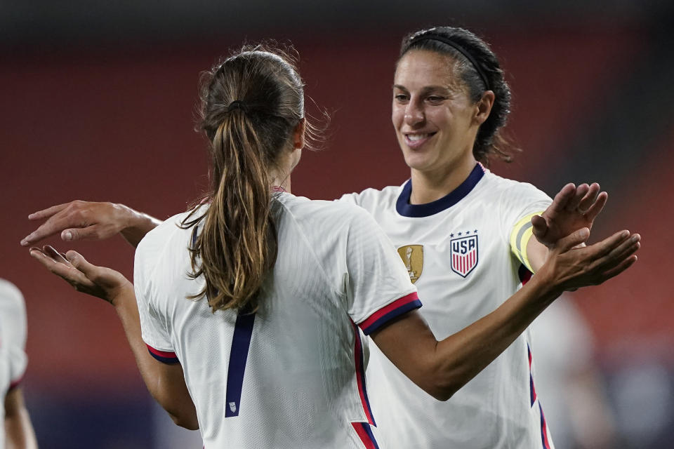 U.S. forward Carli Lloyd, right, congratulates Tobin Heath after Heath scored during the second half of the team's international friendly soccer match against Paraguay, Thursday, Sept. 16, 2021, in Cleveland. The United State won 9-0. (AP Photo/Tony Dejak)