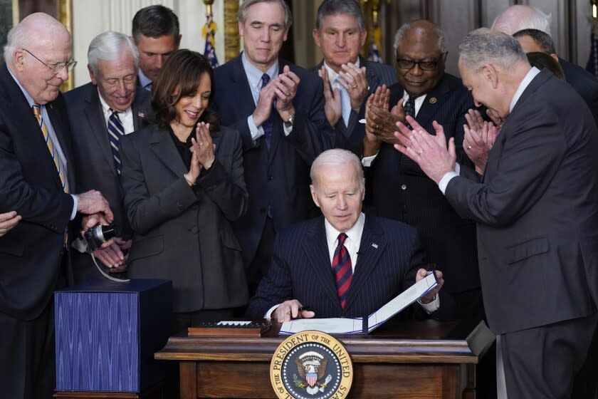 President Joe Biden is applauded after signing the Consolidated Appropriations Act for Fiscal Year 2022