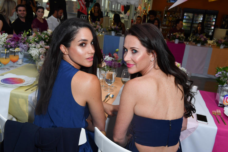 Meghan Markle and Jessica Mulroney turn to face the camera during a dinner. (Getty Images)