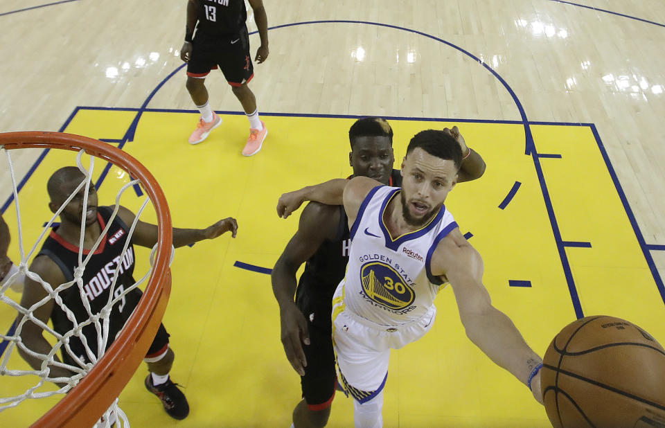 Golden State Warriors guard Stephen Curry (30) shoots in front of Houston Rockets center Clint Capela during the first half of Game 1 of a second-round NBA basketball playoff series in Oakland, Calif., Sunday, April 28, 2019. (AP Photo/Jeff Chiu, Pool)