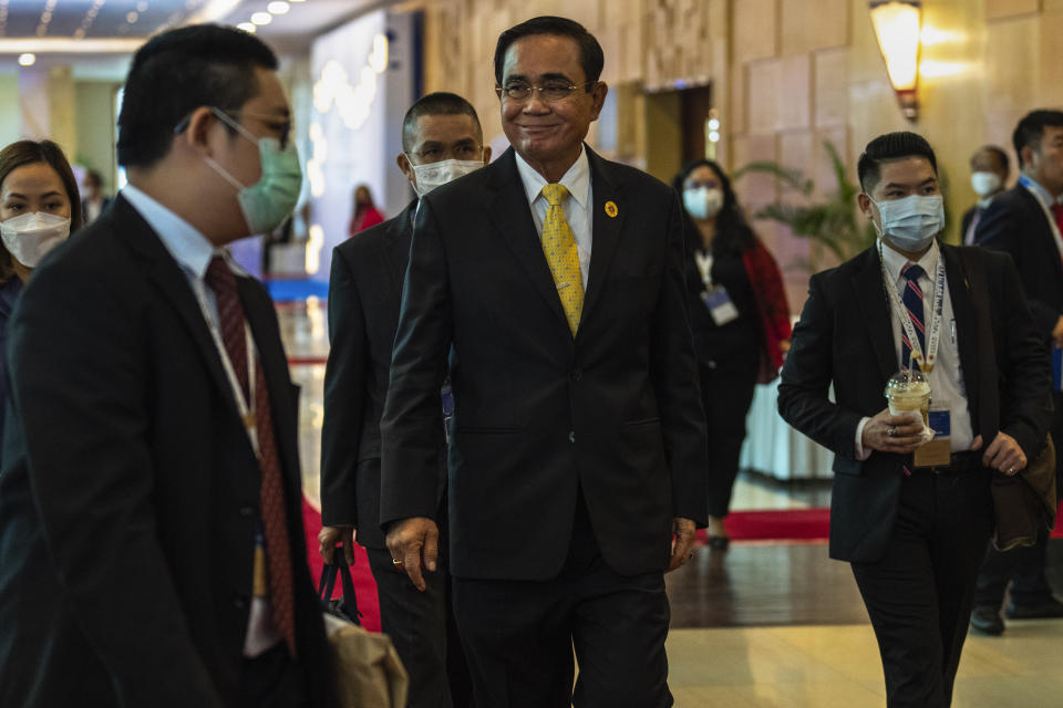 Thailand's Prime Minister Prayuth Chan-ocha, middle, arrives for the ASEAN summit in Phnom Penh, Cambodia, Friday, Nov. 11, 2022. 2022. The ASEAN summit kicks off a series of three top-level meetings in Asia, with the Group of 20 summit in Bali to follow and then the Asia Pacific Economic Cooperation forum in Bangkok. (AP Photo/Anupam Nath)