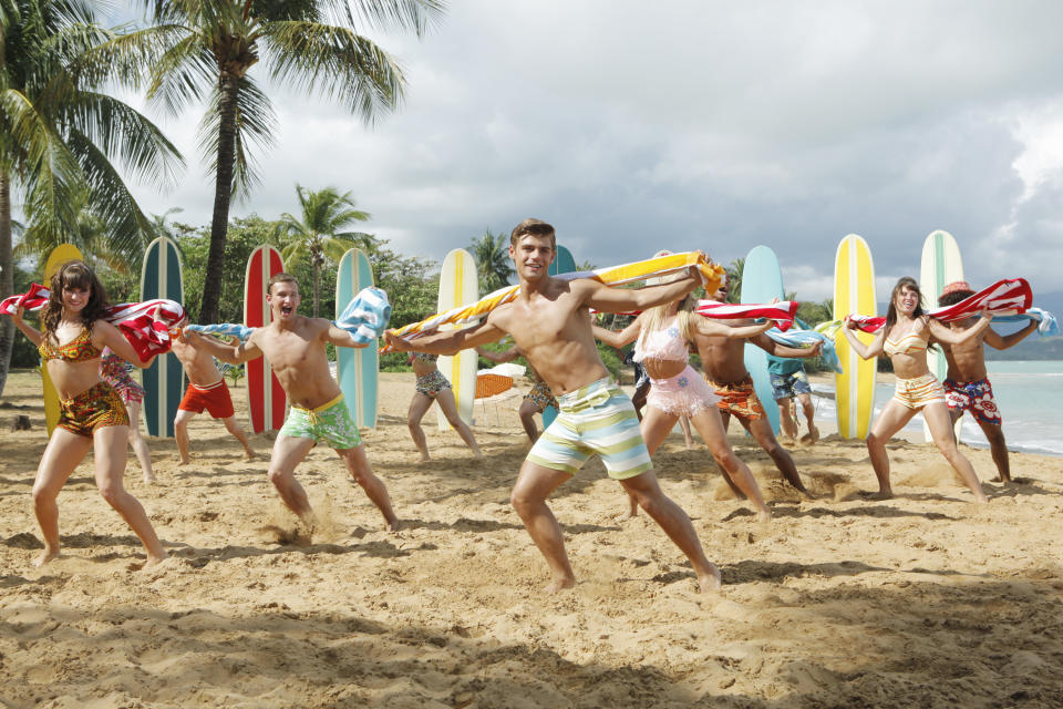 In this publicity image released by Disney Channel, Garrett Clayton, center, appears in a scene from the film "Teen Beach Movie." The film, a modern take on classic beach party movies, airs Friday, July 19 at 8 p.m. EST on the Disney Channel. (AP Photo/Disney Channel, Francsico Roman)