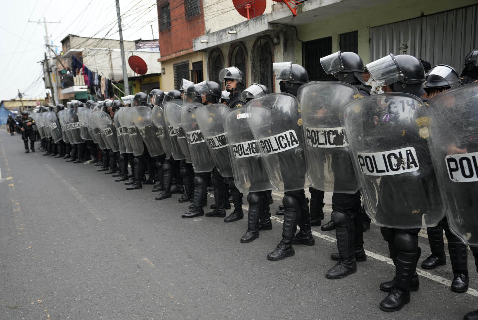 Police in riot stand on a highway blocked by demonstrators during a national strike, in Guatemala City, Tuesday, Oct. 10, 2023. People are protesting to support President-elect Bernardo Arévalo after Guatemala's highest court upheld a move by prosecutors to suspend his political party over alleged voter registration fraud. (AP Photo/Moises Castillo)