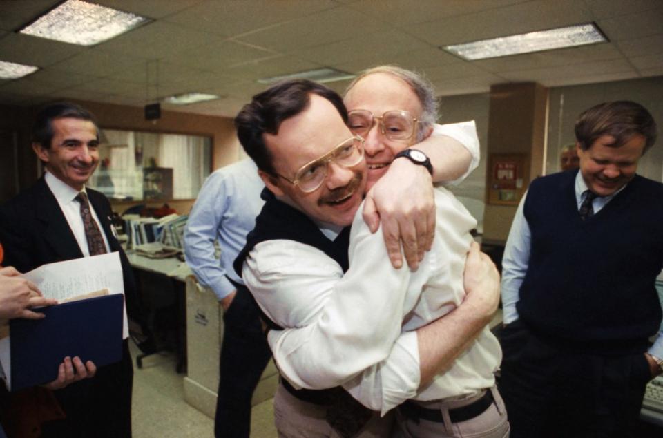 Anderson embracing his colleague Jim Abrams during his visit to the Washington bureau of the AP. AP Photo/Greg Gibson, File