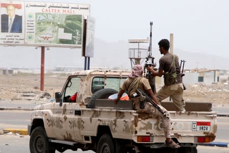 Members of UAE-backed southern Yemeni separatist forces patrol a road during clashes with government forces in Aden