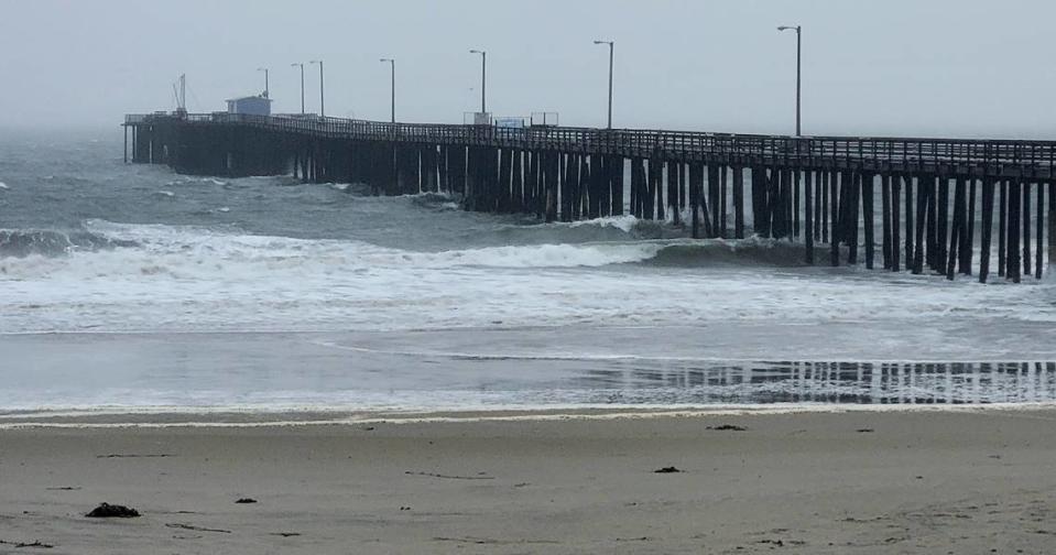 Large wind-whipped waves wash over the Avila Beach Pier in Avila Beach, CA on the evening of Saturday, Dec. 10, 2022.