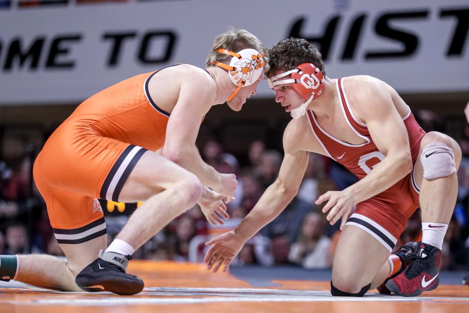 Oklahoma’s Tate Piklo grapples with Oklahoma Sate’s Dustin Plott during a college wrestling meet between the Oklahoma State Cowboys (OSU) and the Oklahoma Sooners at Gallagher-Iba Arena in Stillwater, Okla., Thursday, Feb. 16, 2023.