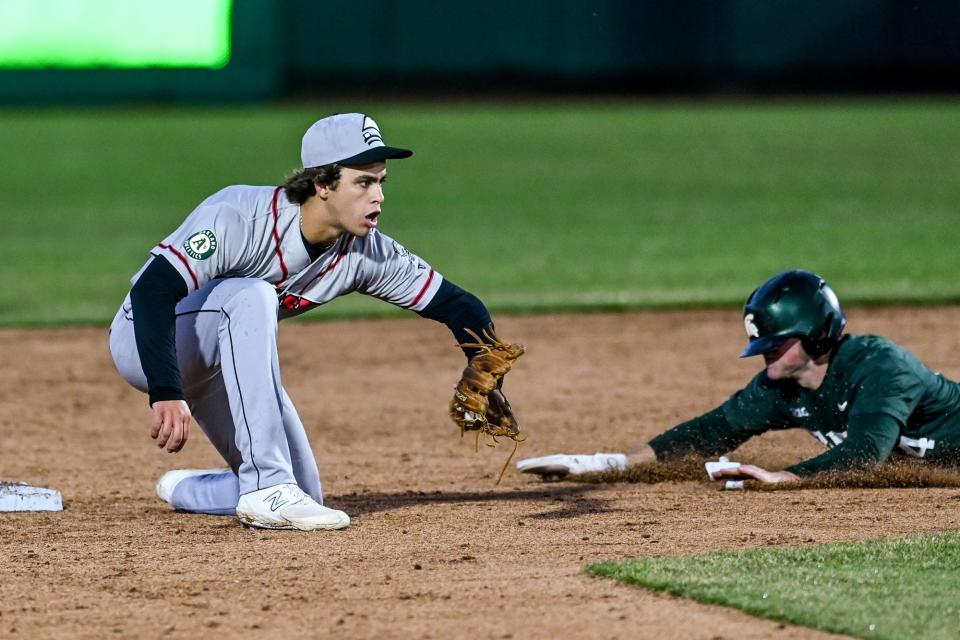 Lugnuts' Max Muncy, left, prepares to tag out Michigan State's Mitch Jebb in the third inning on Tuesday, April 4, 2023, during the Crosstown Showdown at Jackson Field in Lansing.