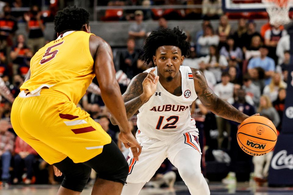 Auburn guard Zep Jasper (12) tries to get around Louisiana-Monroe guard Reginald Gee (5) during the second half of an NCAA college basketball game Friday, Nov. 12, 2021, in Auburn, Ala. (AP Photo/Butch Dill)