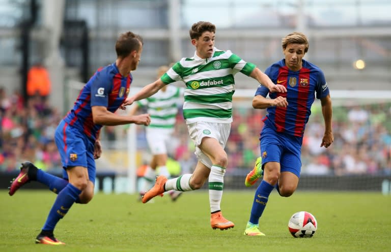 Celtic's Scottish midfielder Ryan Christie fights off a challenge from Barcelona's Sergi Samper (R) and Juan Camara (L) at the Aviva Stadium in Dublin on July 30, 2016