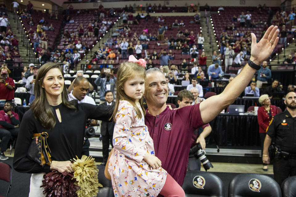 Florida State's new head football coach Mike Norvell, his wife Maria and five year old daughter Mila are introduced during a time out in the first half of an NCAA college basketball game against Clemson in Tallahassee, Fla., Sunday, Dec. 8, 2019. (AP Photo/Mark Wallheiser)