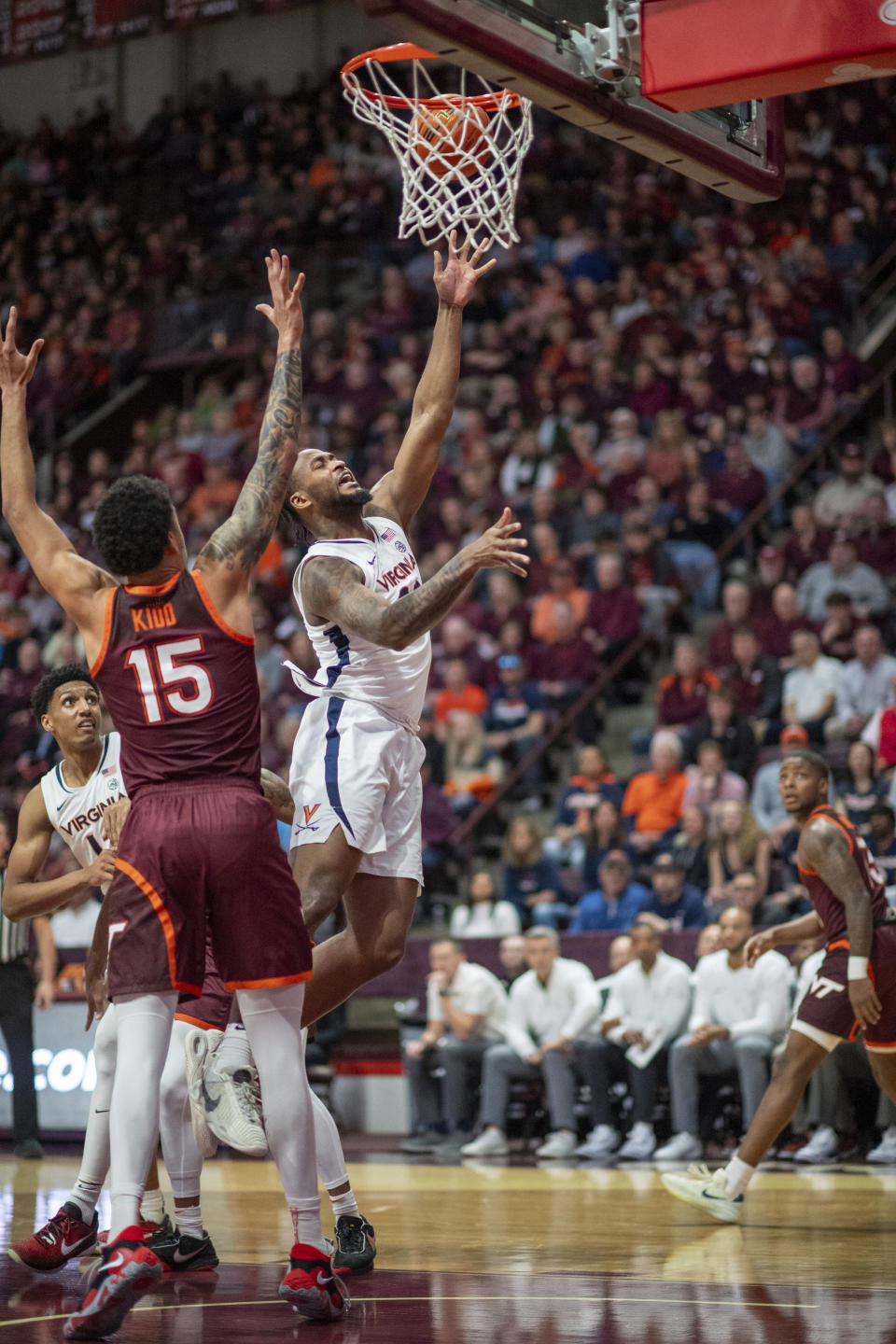 Virginia's Jordan Minor goes up to the basketball against Virginia Tech's Lynn Kidd during the second half of an NCAA college basketball game, Monday, Feb. 19, 2024, in Blacksburg, Va. (AP Photo/Robert Simmons)