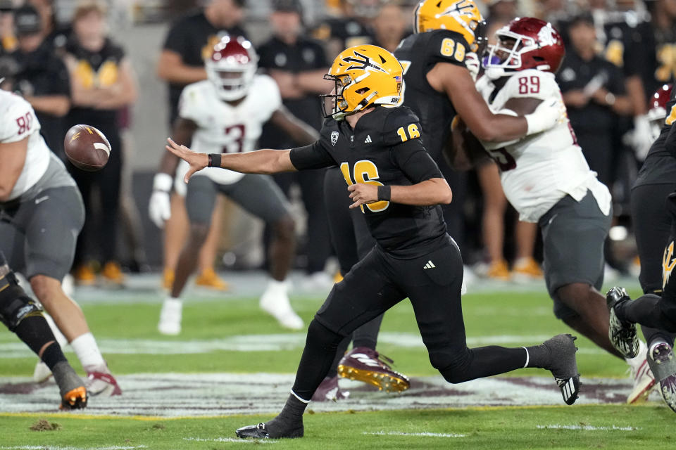 Arizona State quarterback Trenton Bourguet (16) tosses the ball to a running back during the first half of an NCAA college football game against Washington State, Saturday, Oct. 28, 2023, in Tempe, Ariz. (AP Photo/Ross D. Franklin)