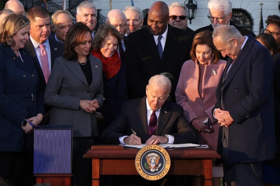 US President Joe Biden signing the bipartisan infrastructure bill in a ceremony outside the White House on 15 November. Negotiations went on for months amid disagreements. (Getty Images)