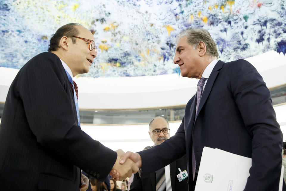 Pakistan's Foreign Minister Shah Mehmood Qureshi, right, shakes hands with China's Ambassador Chen Xu, left, after delivering his statement during the 42nd session of the Human Rights Council at the European headquarters of the United Nations in Geneva, Switzerland, Tuesday, Sept. 10, 2019. (Salvatore Di Nolfi/Keystone via AP)