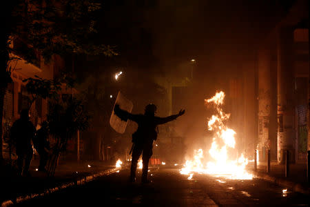 A petrol bomb explodes next to riot policemen following a rally marking the 45th anniversary of a 1973 student uprising against the military dictatorship that was ruling Greece, in Athens, Greece, November 17, 2018. REUTERS/Costas Baltas