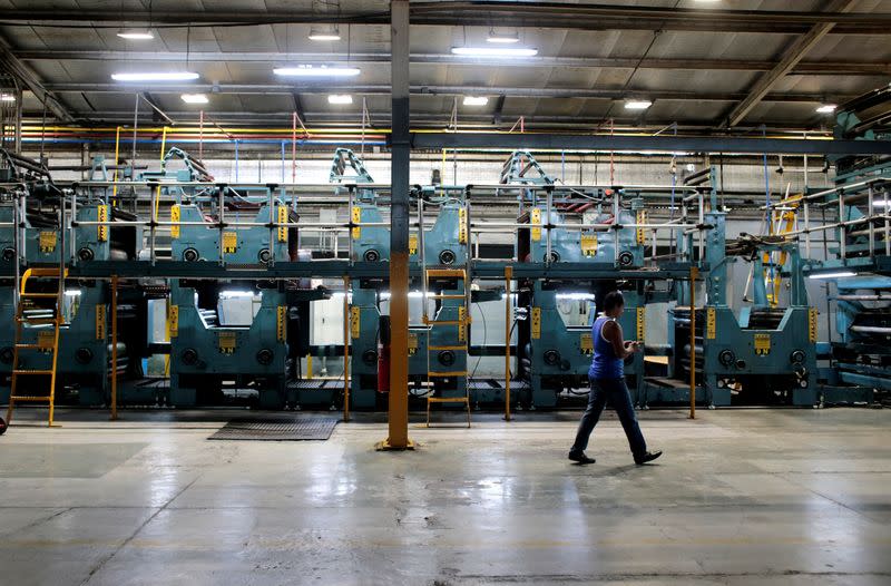 FILE PHOTO: A worker walks inside of La Prensa newspaper printing plant in Managua