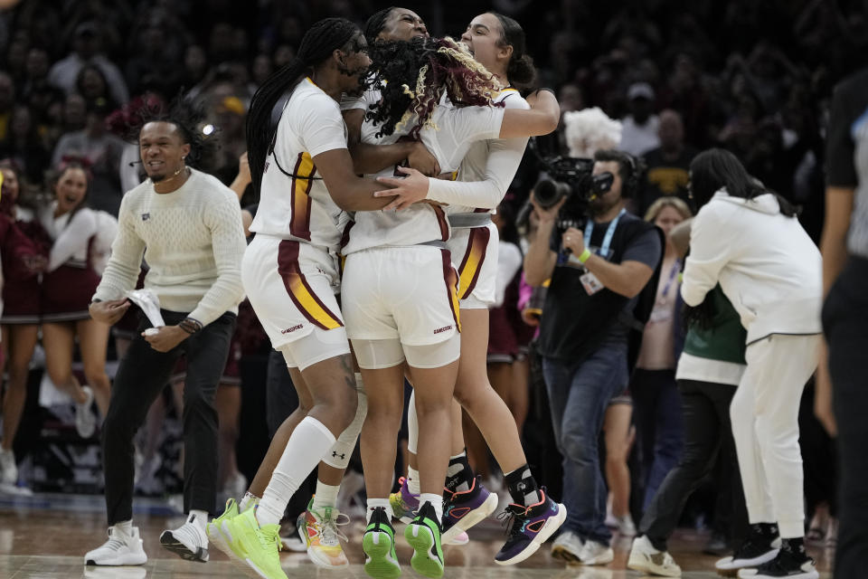 South Carolina players celebrate at the end of the Final Four college basketball championship game against Iowa in the women's NCAA Tournament, Sunday, April 7, 2024, in Cleveland. South Carolina won 87-75. (AP Photo/Morry Gash)