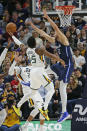 Utah Jazz guard Donovan Mitchell (45) goes to the basket as Dallas Mavericks forward Maxi Kleber (42) defends in the first half during an NBA basketball game Saturday, Jan. 25, 2020, in Salt Lake City. (AP Photo/Rick Bowmer)