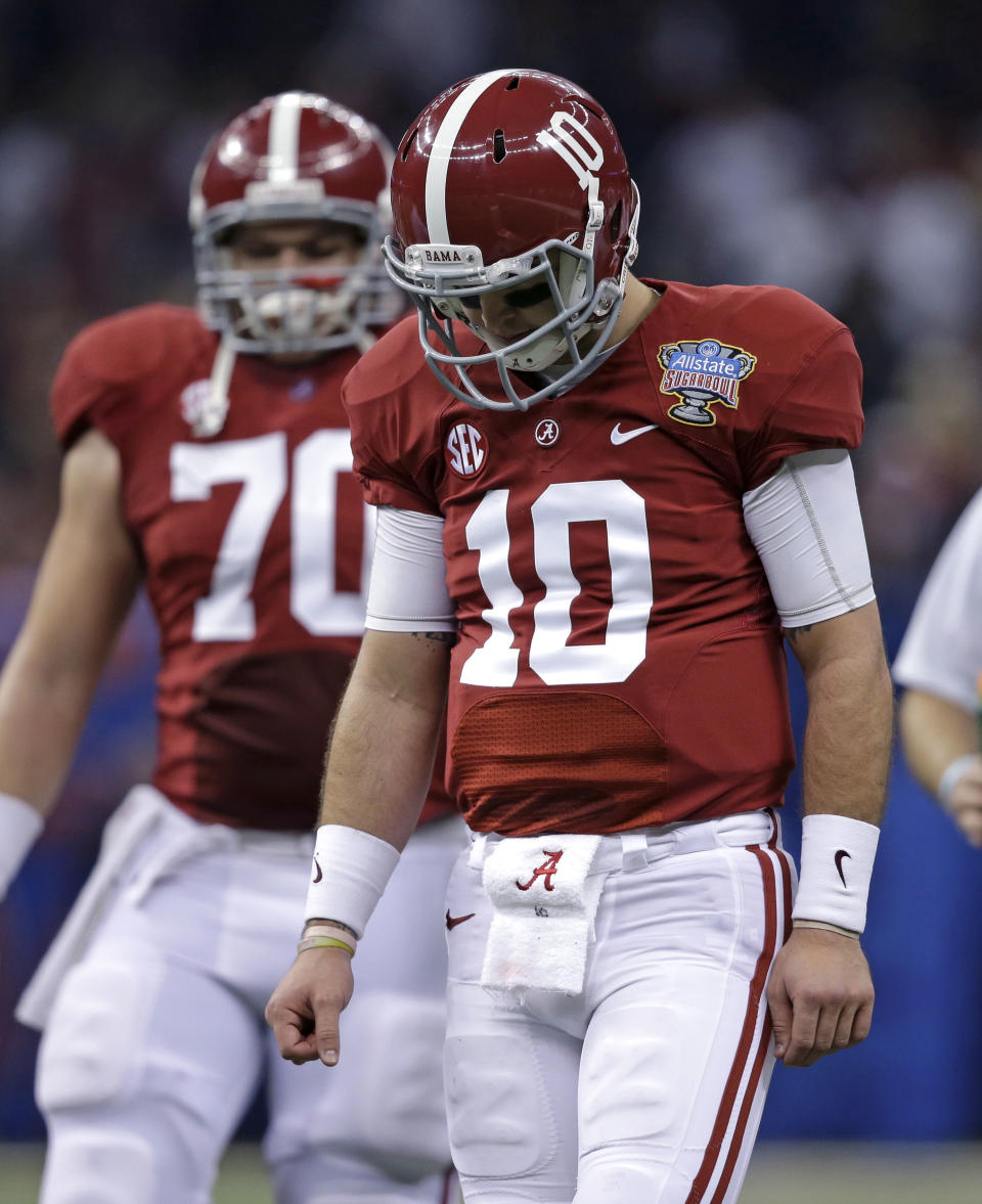 Alabama quarterback AJ McCarron (10) and offensive linesman Ryan Kelly (70) walk off the field after McCarron was sacked by Oklahoma during the first half of the Sugar Bowl NCAA college football game, Thursday, Jan. 2, 2014, in New Orleans. (AP Photo/Patrick Semansky)