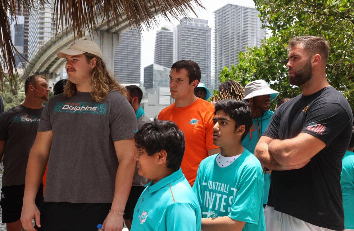 Clockwise from the left: Blaise Andries, offensive lineman of the Miami Dolphins rookie class,Tanner Conner, tight end, and Kellen Diesch, another offensive lineman, listen to a historic walking tour with Bilan Siddiqui, 14, and Zain Khan, 11, kids from the Islamic Center of Greater Miami, during a historic walking tour of Downtown Miami on Wednesday, June 15, 2022, beginning with tour leaders at the History Miami Museum.