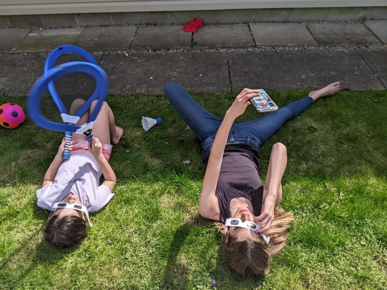 Abbey's daughters wait for the solar eclipse to pass over their town April 8.