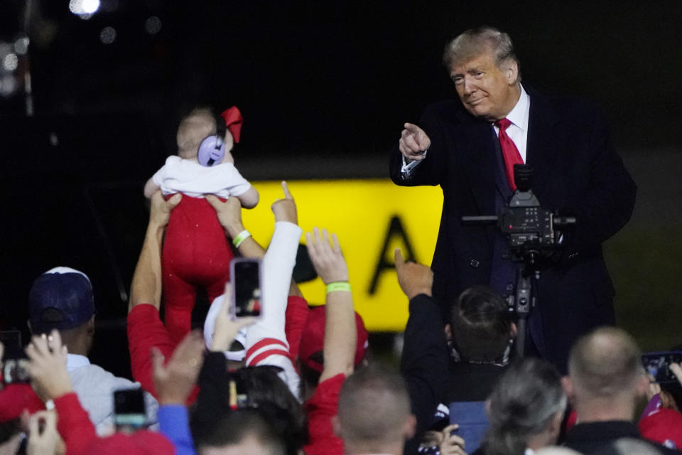 President Donald Trump wraps up his speech and points to an infant at a campaign rally at Fayetteville Regional Airport, Saturday, Sept. 19, 2020, in Fayetteville, N.C. (AP Photo/Chris Carlson)