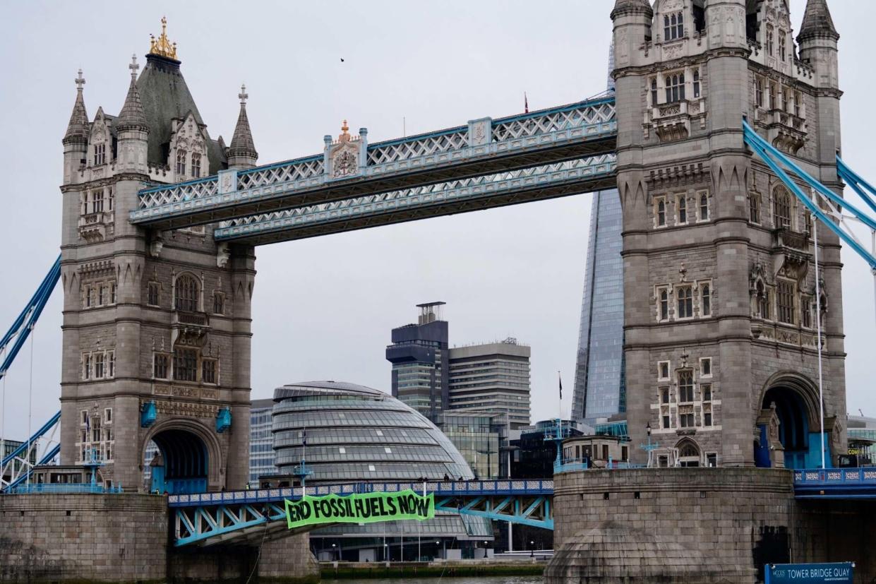 Protestors brought London to a standstill after abseiling off Tower Bridge on Friday morning. (Extinction Rebellion/Twitter)