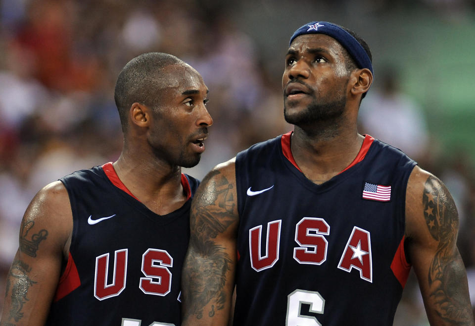 USA's Kobe Bryant (L) looks at USA's LeB