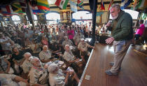 In this Saturday, July 23, 2022, photo provided by the Florida Keys News Bureau, Gerrit Marshall, right, endeavors to convince the judges he should win the 2022 Hemingway Look-Alike Contest at Sloppy Joe's Bar in Key West, Fla. Marshall was selected among the best five of 125 entrants, but was not chosen in the finals. The contest was the highlight event of Key West's annual Hemingway Days festival that ends Sunday, July 24. Hemingway lived and wrote in Key West during most of the 1930s. (Andy Newman/Florida Keys News Bureau via AP)