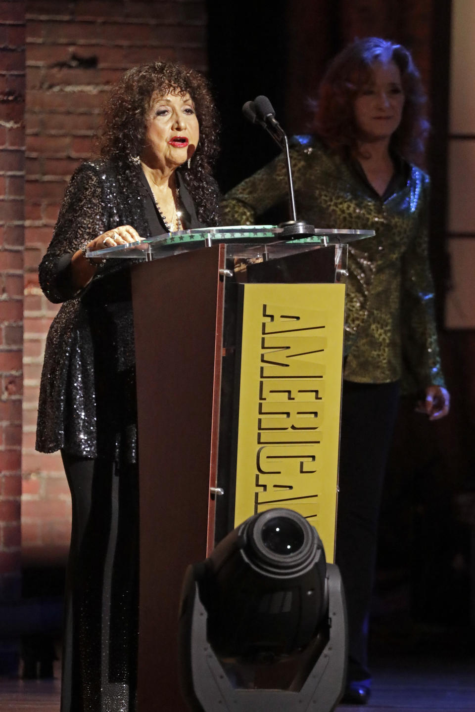 Maria Muldaur accepts the Trailblazer Award after it was presented to her by Bonnie Raitt, right, at the Americana Honors & Awards show Wednesday, Sept. 11, 2019, in Nashville, Tenn. (AP Photo/Wade Payne)