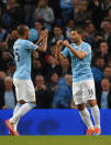 Manchester City's Sergio Aguero, right, celebrates after scoring against West Bromwich Albion with teammate Fernandinho during the English Premier League soccer match at the Etihad Stadium, Manchester, England, Monday April 21, 2014. (AP Photo/Rui Vieira)