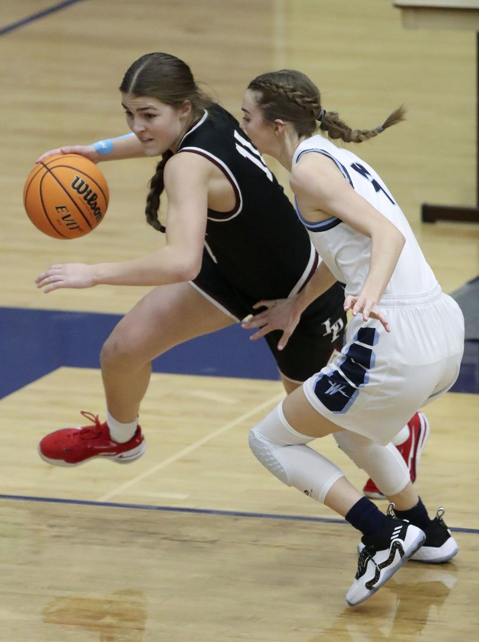 Lone Peak’s Kailey Woolston, wearing black, dribbles around Westlake’s Paige Payne