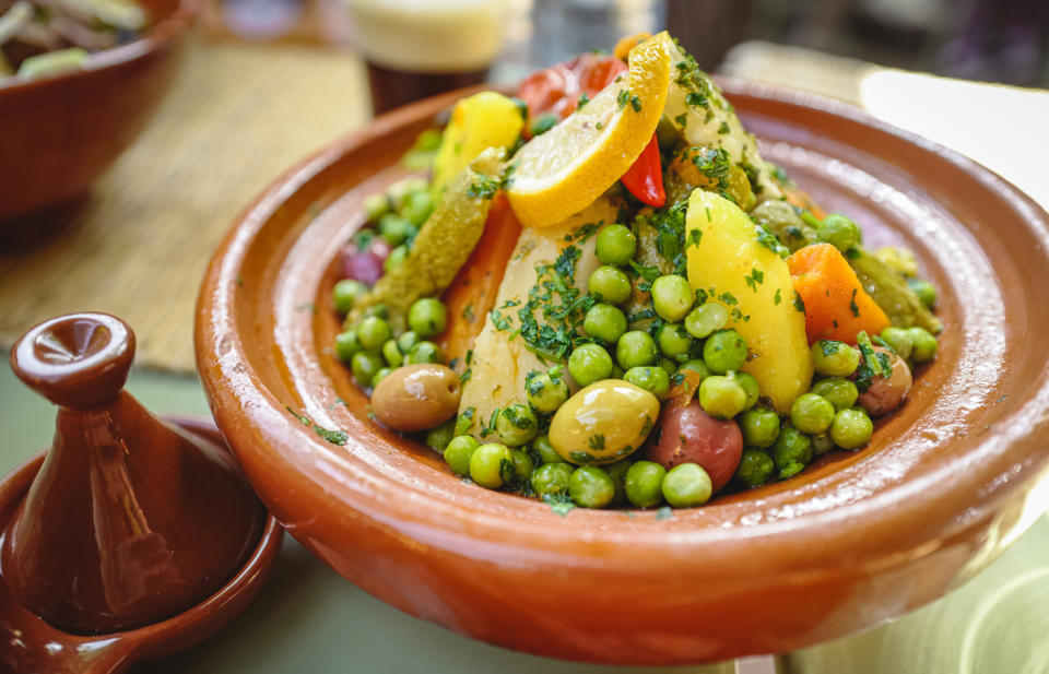 Traditional Moroccan tagine with vegetables and garnish on the table