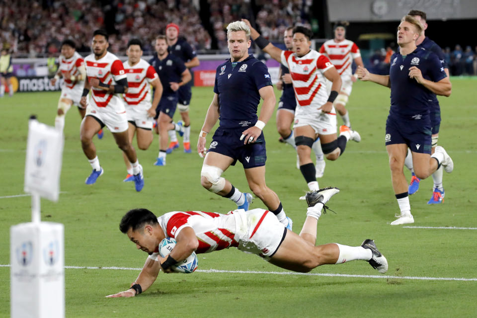 Japan's Kenki Fukuoka crosses for his team's third try during the Rugby World Cup Pool A game at International Stadium between Japan and Scotland in Yokohama, Japan, Sunday, Oct. 13, 2019. (AP Photo/Christophe Ena)