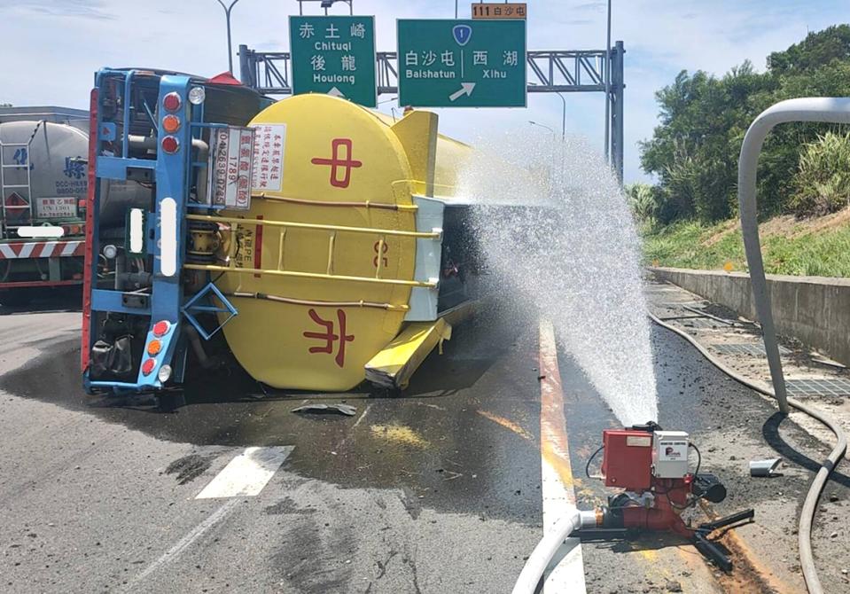 一輛載運23噸鹽酸溶液的大型槽車，6日行經台61線北 上白沙屯路段，突然失控翻覆，有少量鹽酸外洩，苗栗 縣消防局獲報趕赴將受傷駕駛送醫，並在現場灑水稀釋 。（民眾提供）