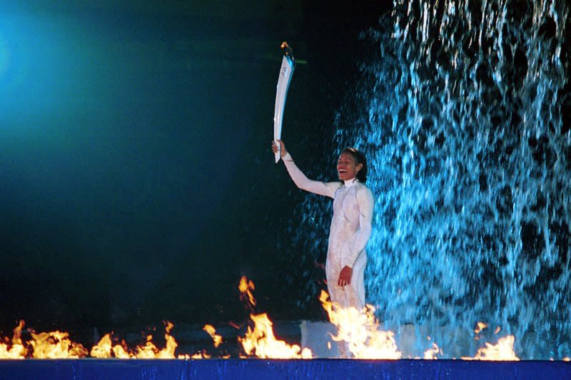 Australia's 400m gold medal hope, Cathy Freeman, stands in the pool below the waterfall which she lit with the olympic torch during the Sydney Summer 2000 Olympic opening ceremonies on September 15, 2000. File Photo by Peter J. Thompson/UPI