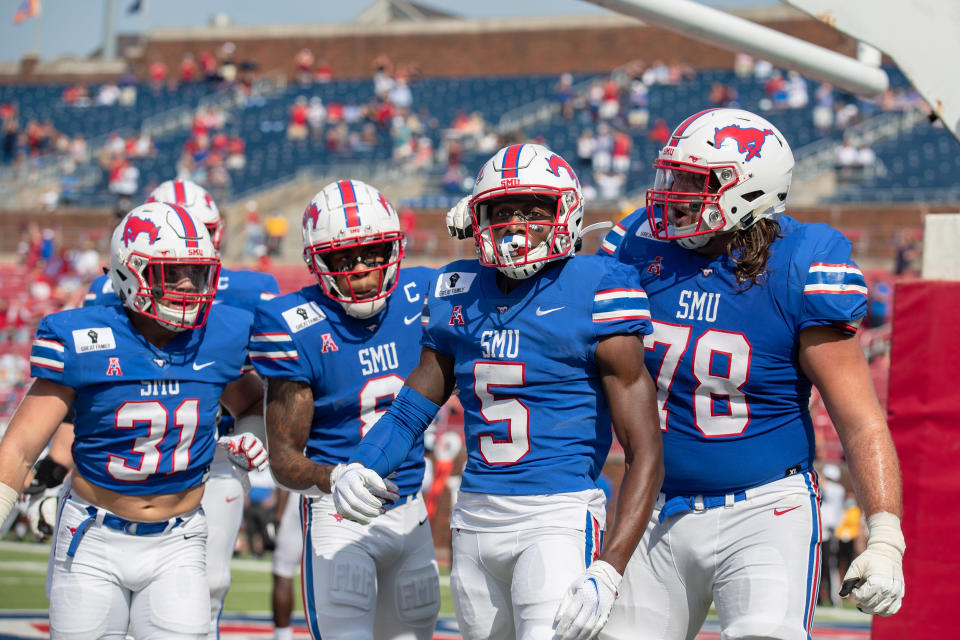 DALLAS, TX - OCTOBER 03: SMU Mustangs wide receiver Danny Gray (#5) and teammates including running back Tyler Lavine (#31), wide receiver Reggie Roberson, Jr. (#8), and offensive lineman Beau Morris (#78) celebrate after Gray scored a touchdown during the college football game between the SMU Mustangs and Memphis Tigers on October 3, 2020, at Gerald J. Ford Stadium in Dallas, TX.  (Photo by Matthew Visinsky/Icon Sportswire via Getty Images)