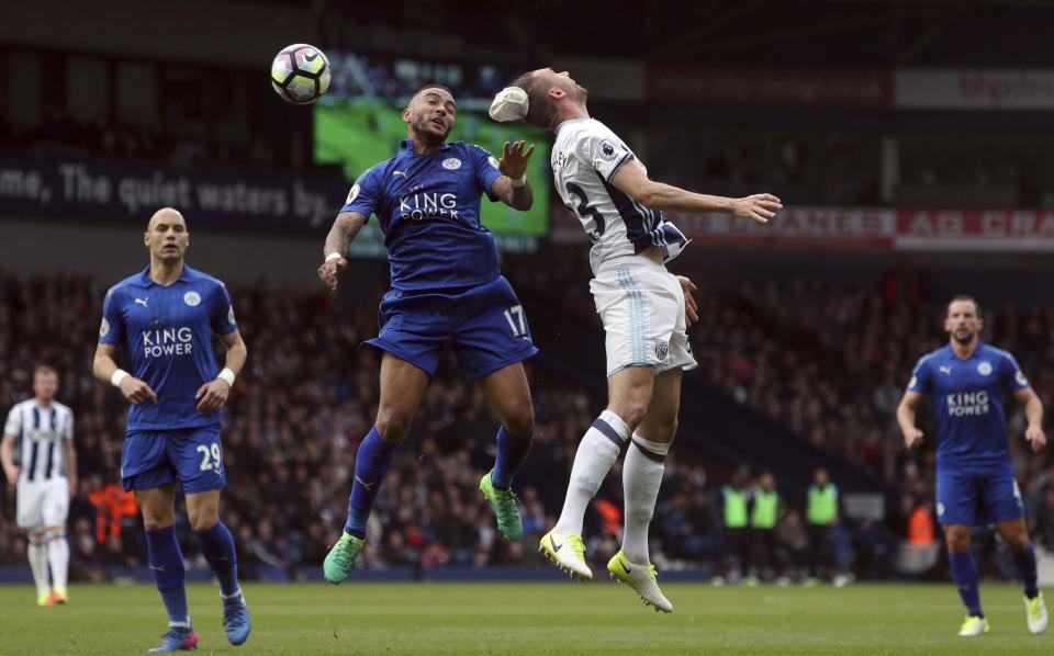<p>West Bromwich Albion’s Gareth McAuley, centre left, and Leicester City’s Danny Simpson contest an aerial ball </p>