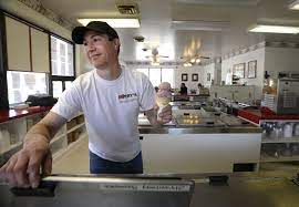 Rob Barry serves ice cream in this file photo from Barry's Ice Cream in Ellwood City.