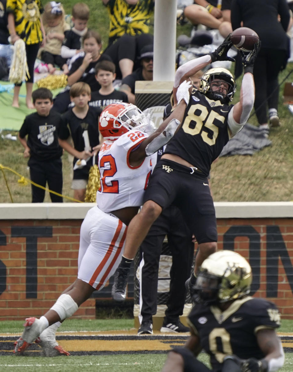 Wake Forest tight end Blake Whiteheart (85) catches a touchdown pass against Clemson linebacker Trenton Simpson (22) during the second half of an NCAA college football game in Winston-Salem, N.C., Saturday, Sept. 24, 2022. (AP Photo/Chuck Burton)