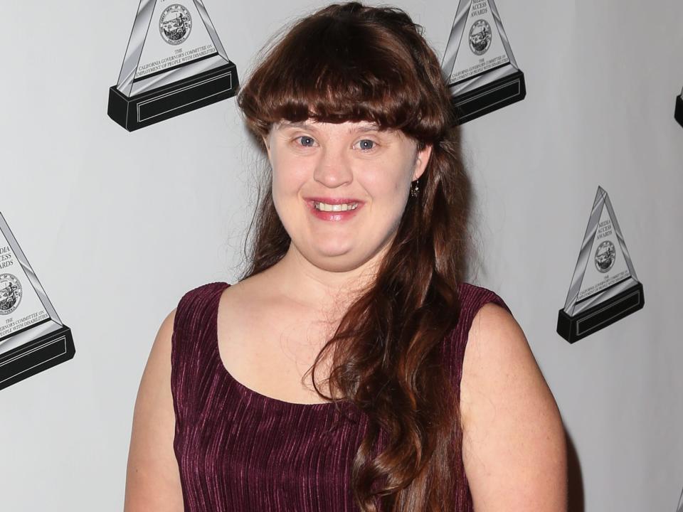 Jamie Brewer in 2012 in purple dress