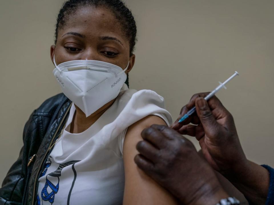 A woman is vaccinated against COVID-19 at the Hillbrow Clinic in Johannesburg, South Africa. While vaccine inequity among African countries has played a major role in the continent's low COVID-19 vaccination rate, capacity and logistical challenges, along with vaccine hesitancy, is also creating significant challenges. (Shiraaz Mohamed/The Associated Press - image credit)