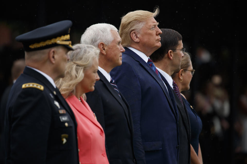 President Donald Trump looks on during an Armed Forces welcome ceremony for the new chairman of the Joint Chiefs of Staff Gen. Mark Milley, Monday, Sept. 30, 2019, at Joint Base Myer-Henderson Hall, Va. From left, Milley, Hollyanne Milley, Vice President Mike Pence, Trump, Defense Secretary Mark Esper, and Leah Esper. (AP Photo/Evan Vucci)