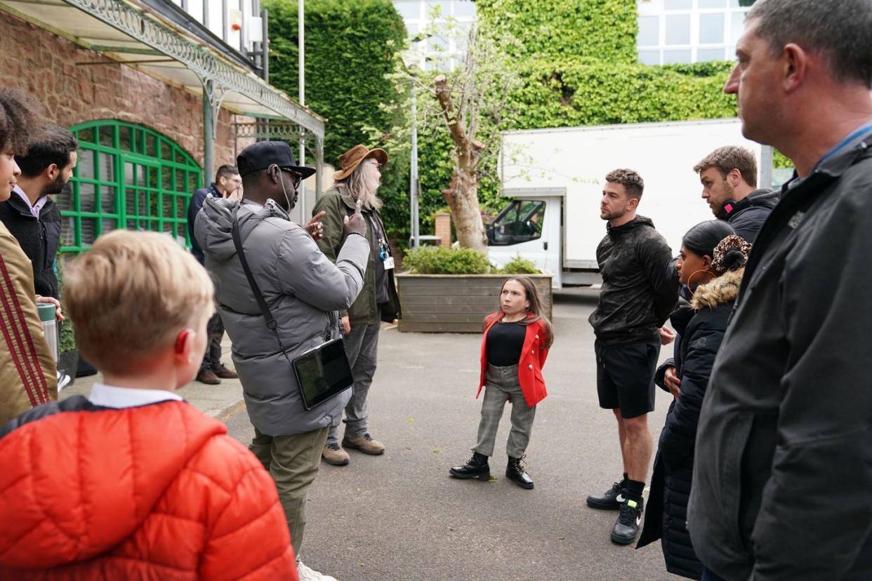 annabelle davis, as lacey in red jacket, and rory douglas speed, as joel dexter in black shirt, filming hollyoaks