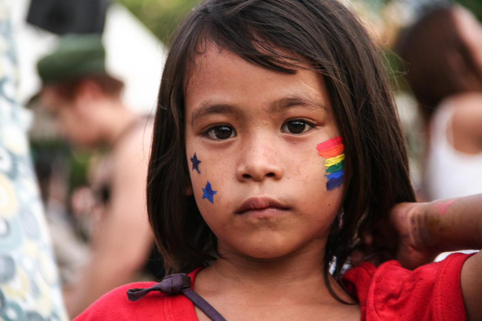 A young kid with a rainbow flag face paint poses for the camera at the Rizal Park in Manila. Thousands of LBGTQ members marched along Manila's main thoroughfare as they celebrate Manila's 21st Gay Pride Parade in 2015. (Photo by J Gerard Seguia/Pacific Press/LightRocket via Getty Images)