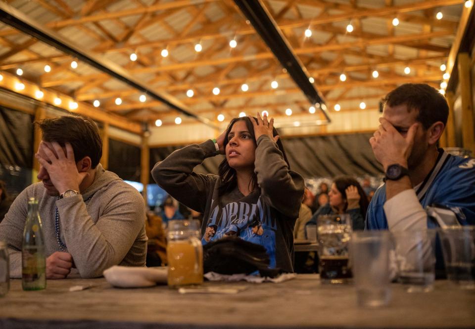 (From left) Steve Reaume, Olivia Esparza and Arthur Griem watch the San Francisco 49ers score a touchdown during the Lions vs Niners NFC championship game inside Batch Brewing Company in Detroit on Sunday, Jan. 28, 2024.