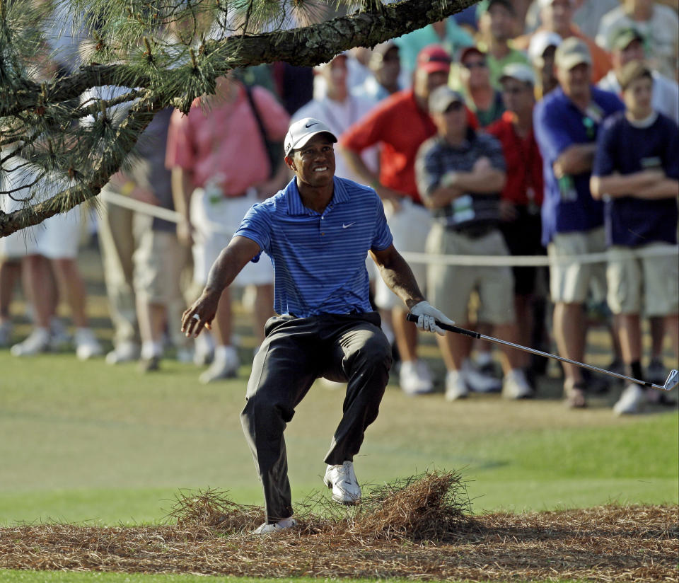 <p>Tiger Woods nearly falls backwards after hitting out of the rough on the 17th hole during the third round of the Masters golf tournament Saturday, April 9, 2011, in Augusta, Ga. (AP Photo/Chris O’Meara) </p>