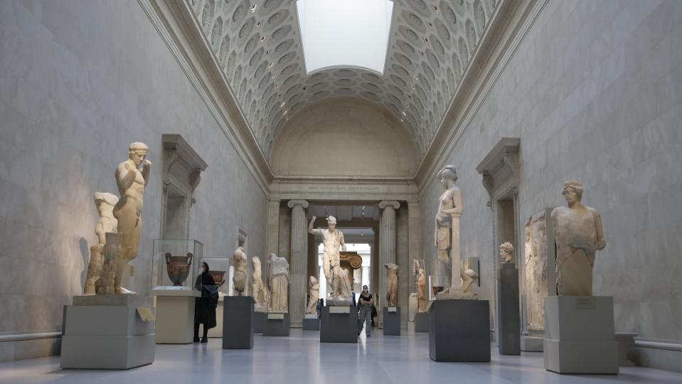 Visitors walking through the Greek and Roman Galleries at the Met.