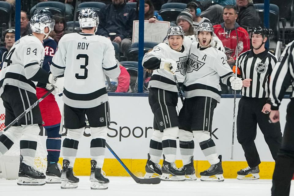 Dec 5, 2023; Columbus, Ohio, USA; Los Angeles Kings center Phillip Danault (24) celebrates a goal with center Trevor Moore (12) during the third period of the NHL game against the Columbus Blue Jackets at Nationwide Arena. The Blue Jackets lost 4-3 in overtime.